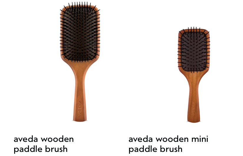 Two wooden paddle brushes from Aveda on a white background