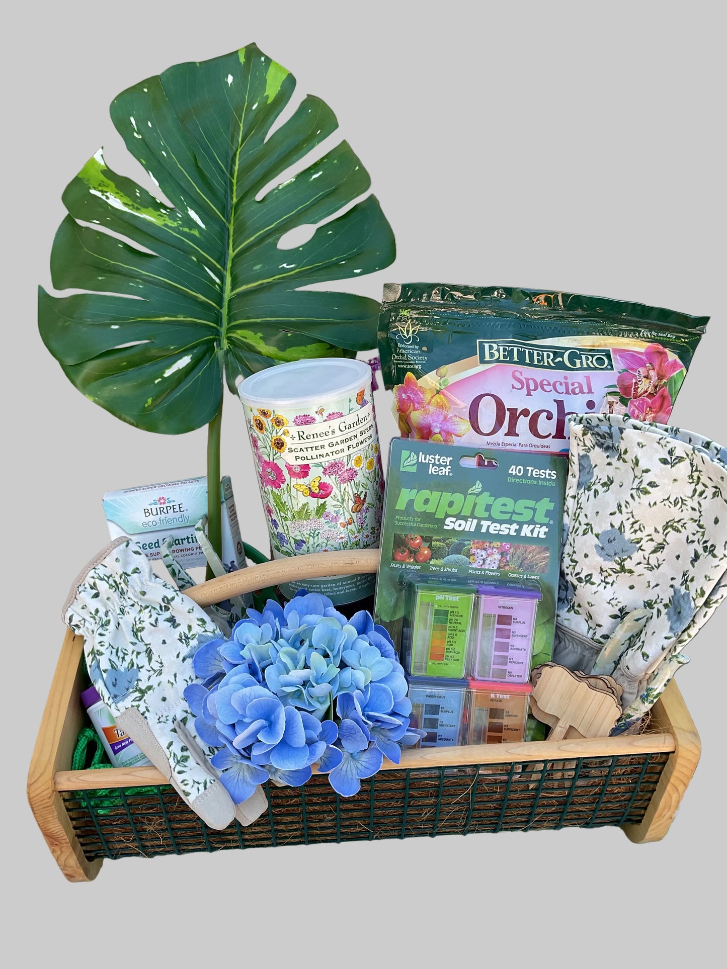 Tray with various items including a plant, flowers, and boxes on a checkered tablecloth.