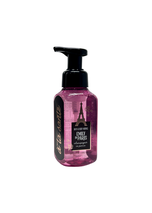 Pink bottle with black pump labeled 'Emily in Paris' on a white background