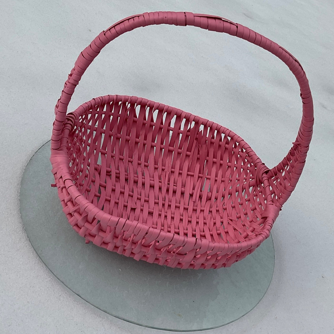 Pink woven basket on a snowy background