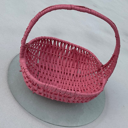 Pink woven basket on a snowy background