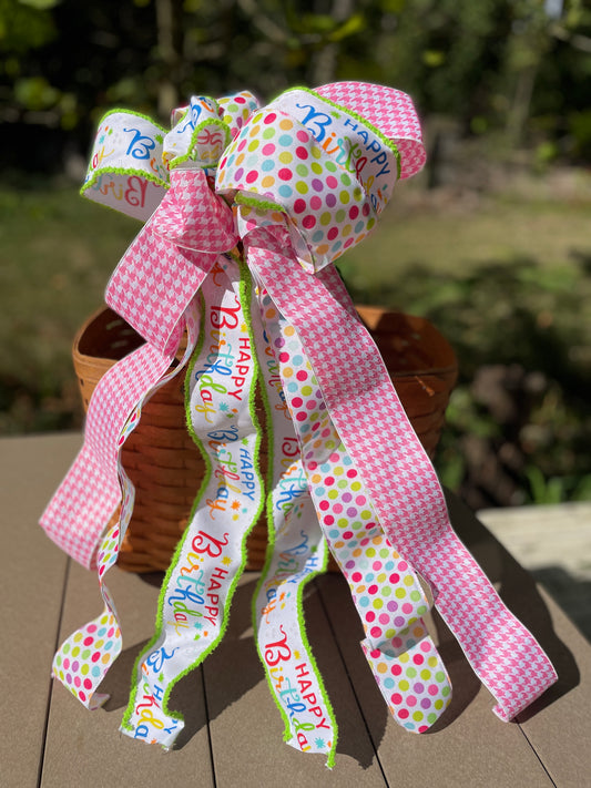 Colorful ribbon with 'Happy Birthday' text on a wooden surface