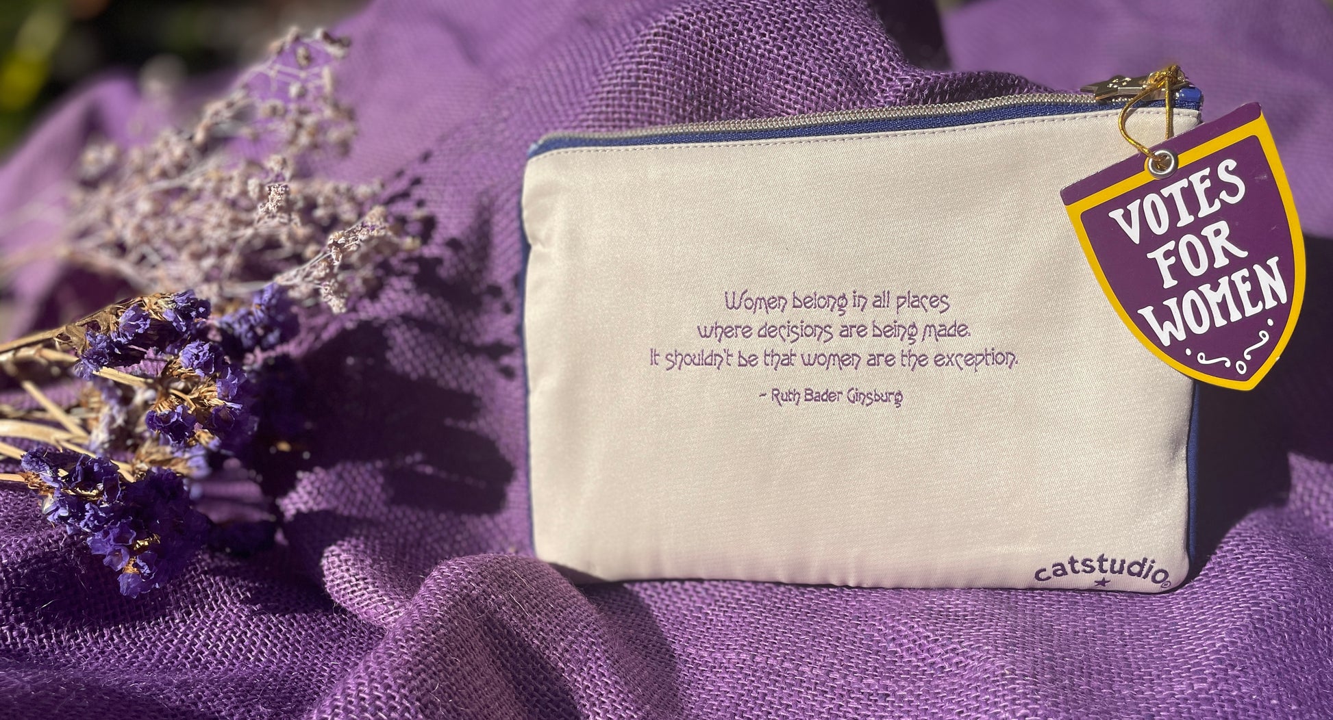 Small pouch with 'Votes for Women' text and quote on a purple fabric background