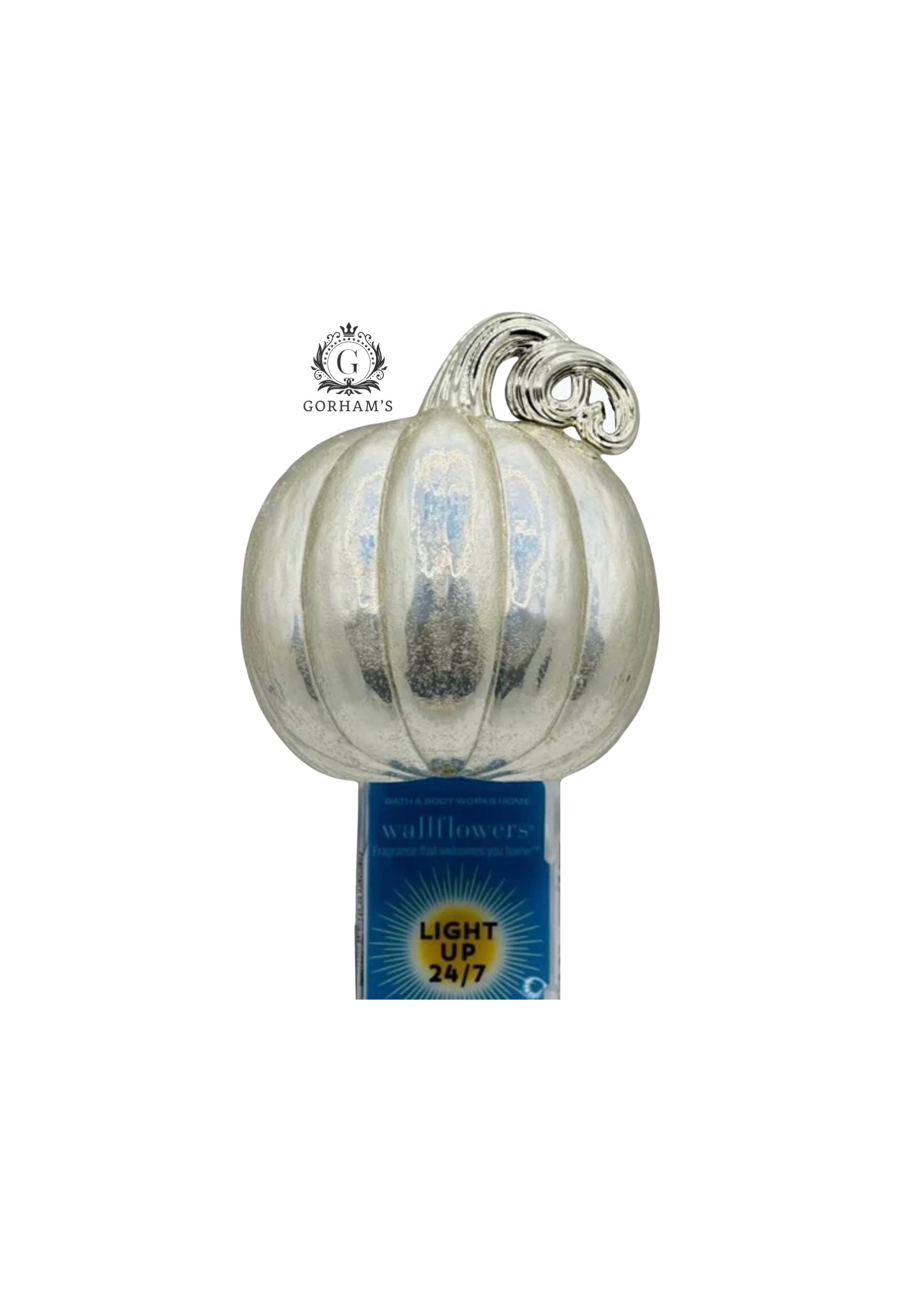 Decorative glass pumpkin with a label on a white background
